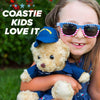 A glitched image shows a smiling person with sunglasses holding the Coast Guard Teddy Bear Personalized Bundle by ZZZ BEARS. Fragmented text like COASTIE, KIDS, and LOVE appears over a colorful background.