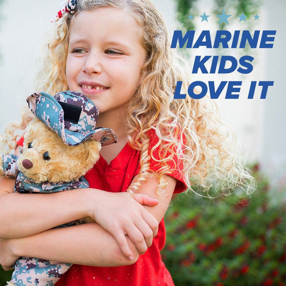A vibrant, distorted image of a child hugging the personalized Marine Cammo Teddy Bear from ZZZ BEARS, with bold black and blue text: "MARINE KIDS LOVE IT." A unique family gift for loved ones in the Marines.